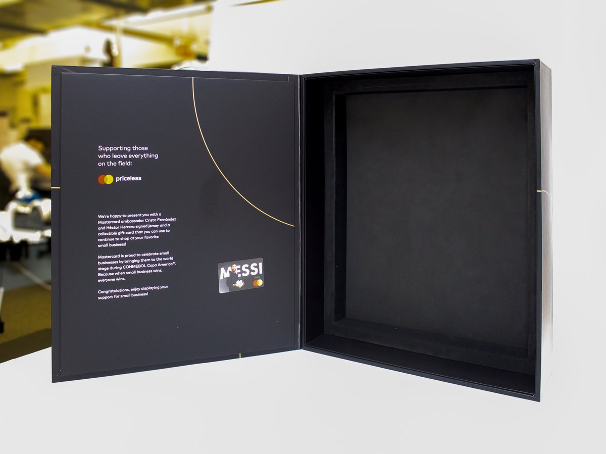 Image 1 shows the empty packaging of the public relations box. Emphasizing its craftsmanship and sleek, black, interior. 