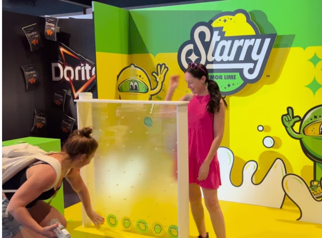 Oversized Plinko Game created to market Starry products. A mother and child are playing with the display.