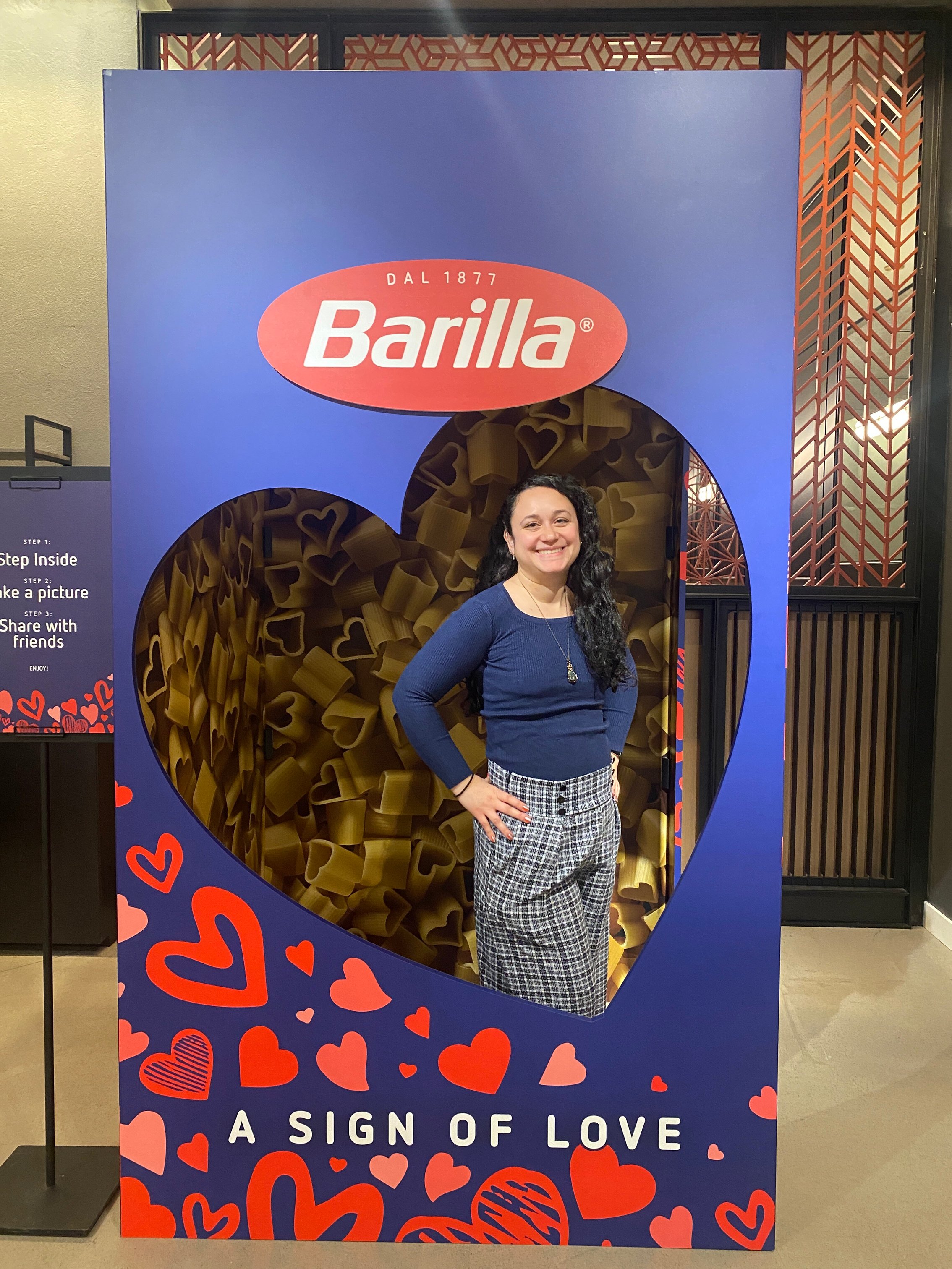 Barilla Custom Photo Booth with heart window cut out and a human standing inside.