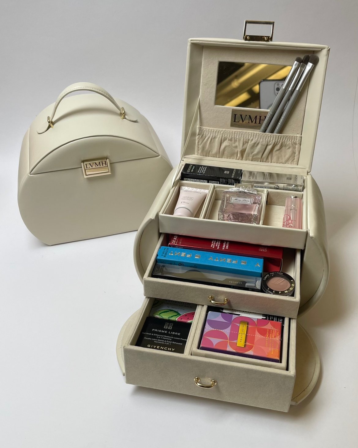 LVMH Influfence box which is intentionally created to be a functional, multi-layered makeup bag. It includes a range of luxury brand goods including Dior perfume, Dior lip balm, make-up brushes, and 10 other designer products.