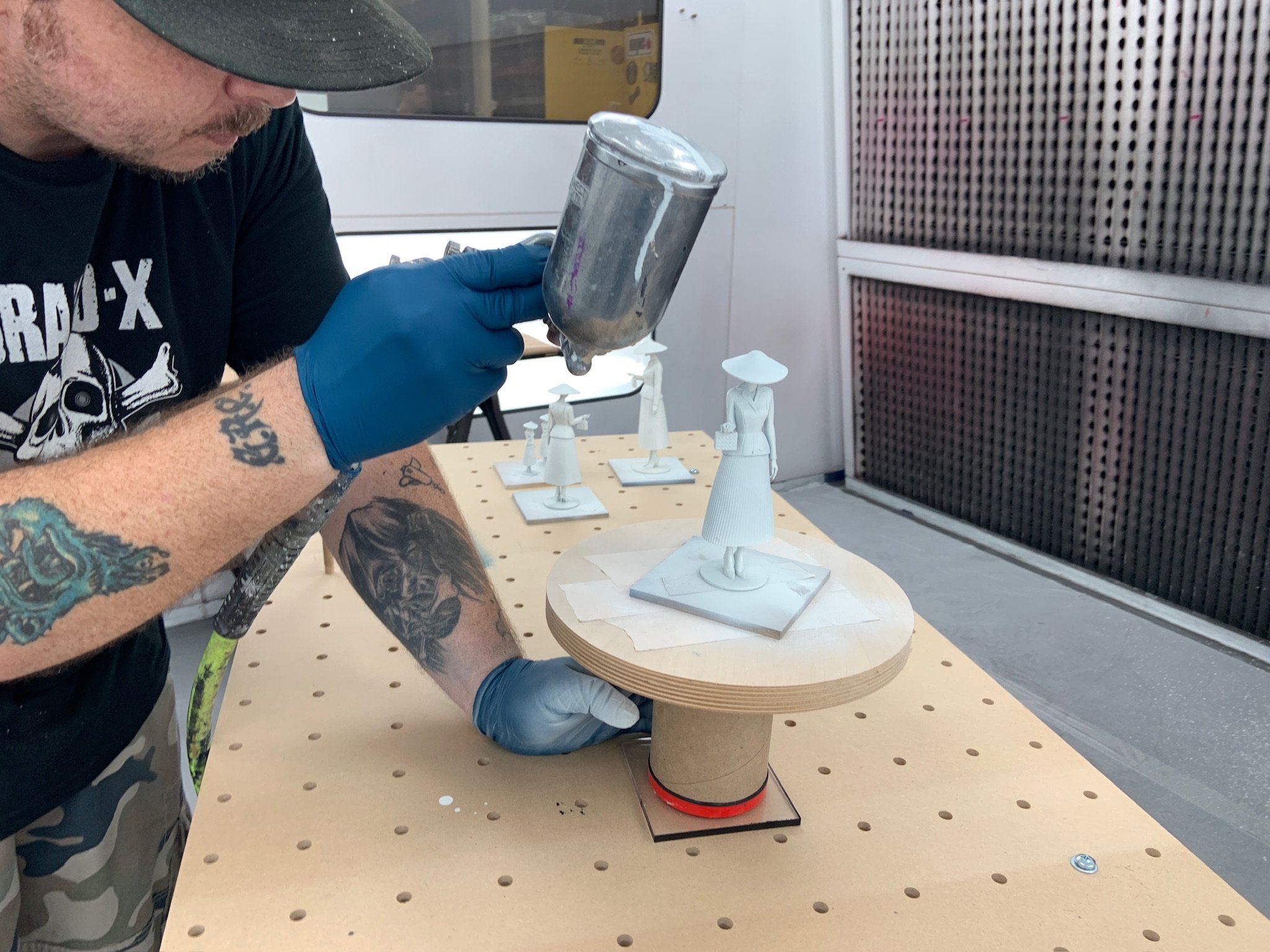 BluEdge employee physically airbrushing each 3D printed figure