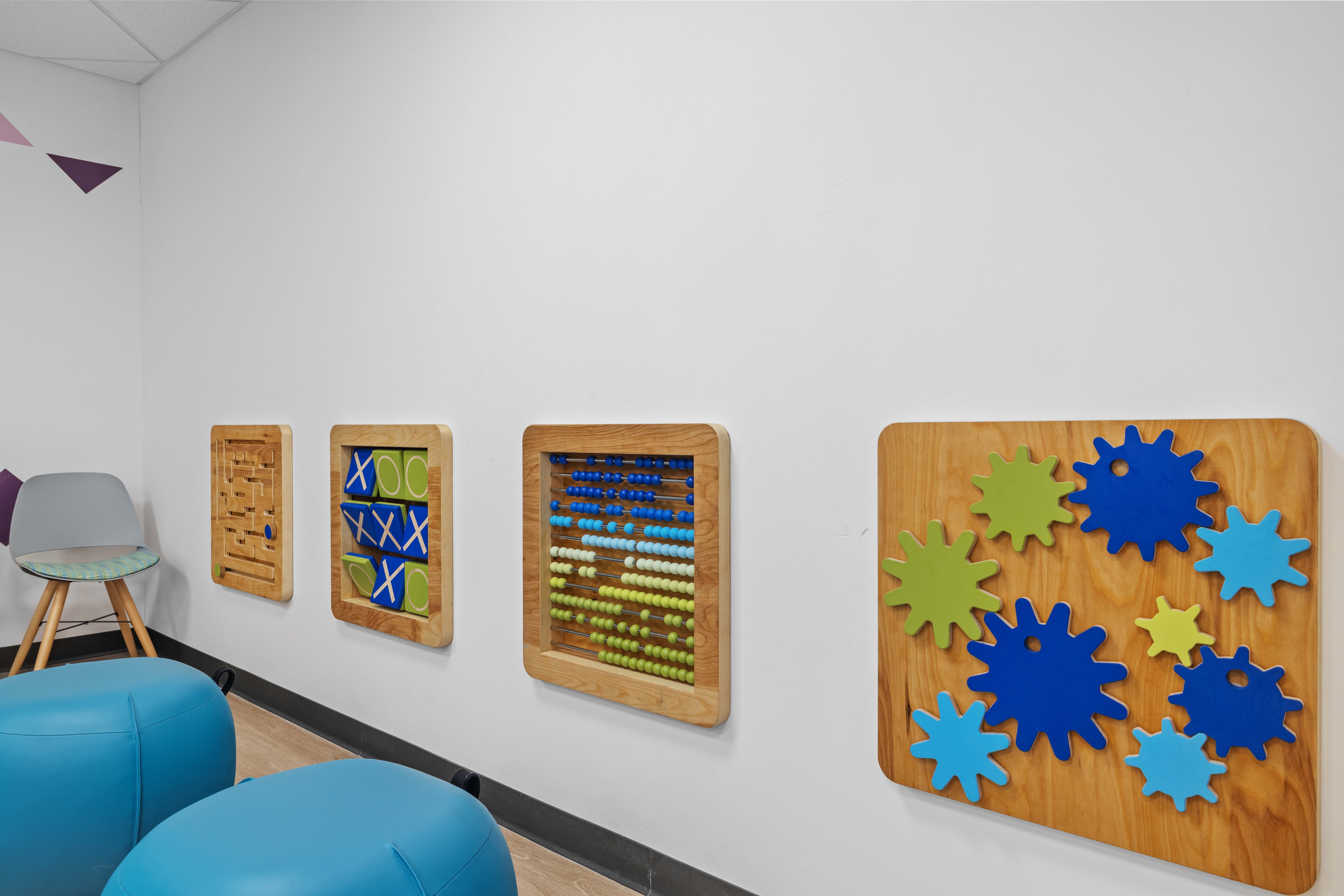 Interactive Wall Games installed at Norwood medical clinic. Child height, solid blue and green color. 