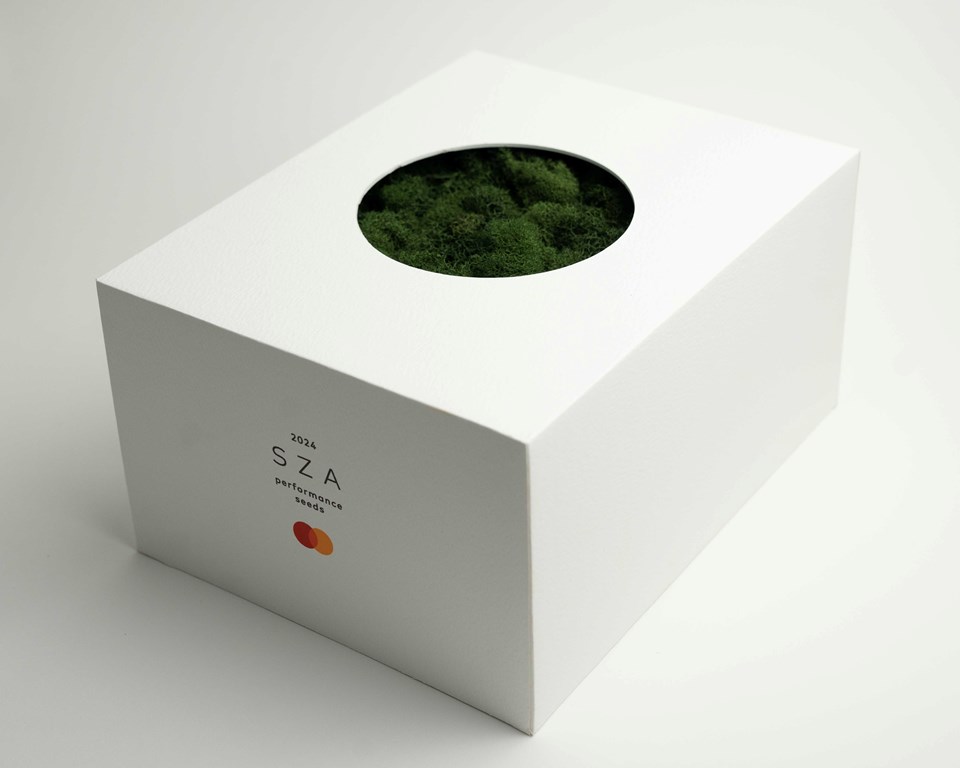 SZA x Mastercard - Performance Seeding Kit packed up into a box with a circular window. A bed of moss can be seen through the window.