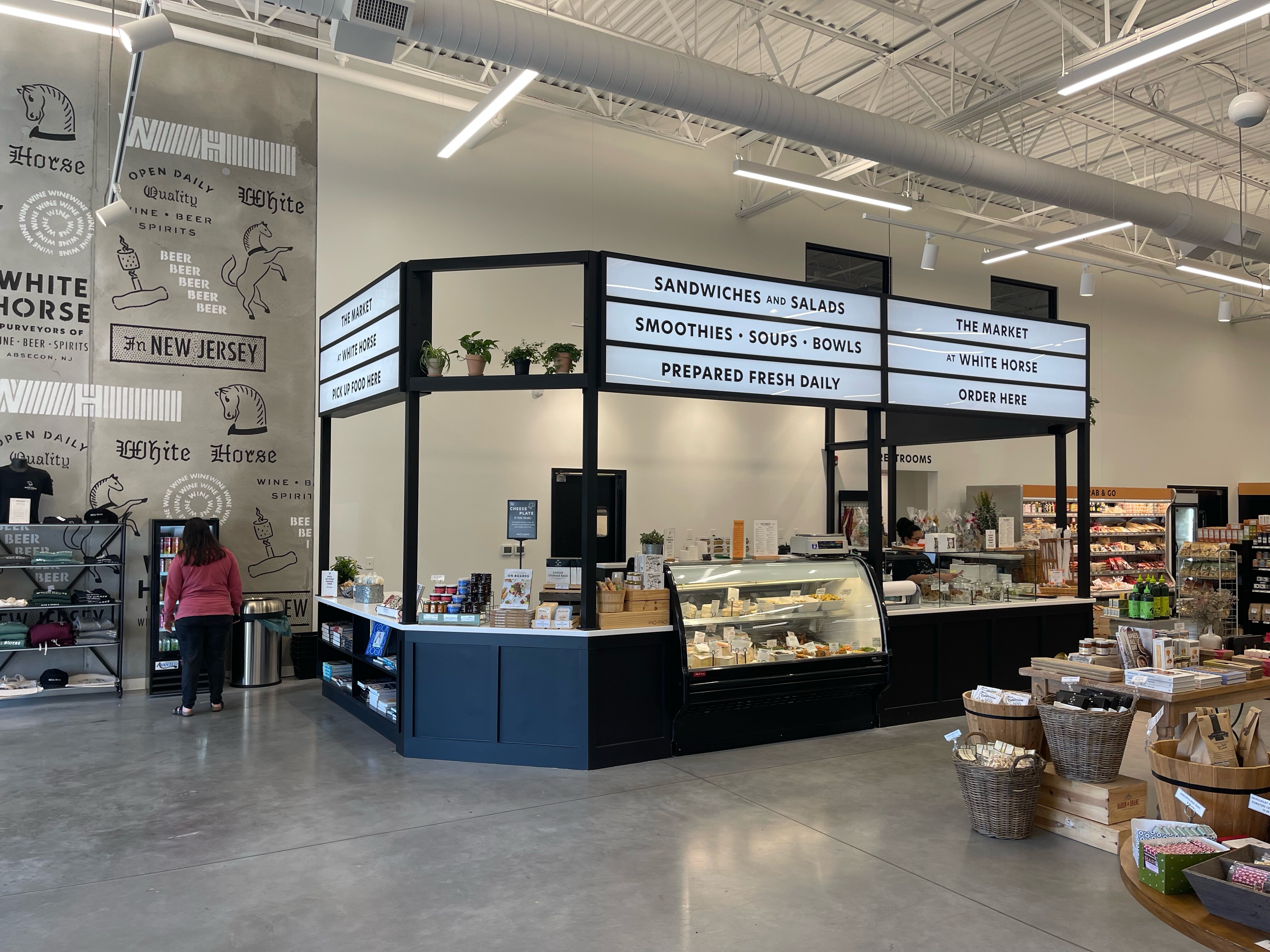 White Horse Wine and Spirits. Signage of menu above food stall inside market building. left side view